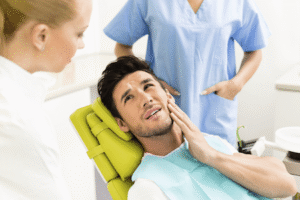 man holding his jaw in pain